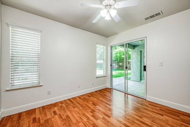 spare room with visible vents, lofted ceiling, baseboards, ceiling fan, and light wood-type flooring