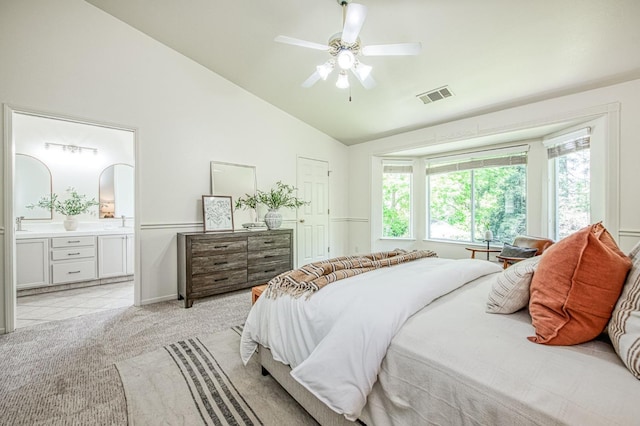 bedroom featuring visible vents, ensuite bath, multiple windows, and light colored carpet