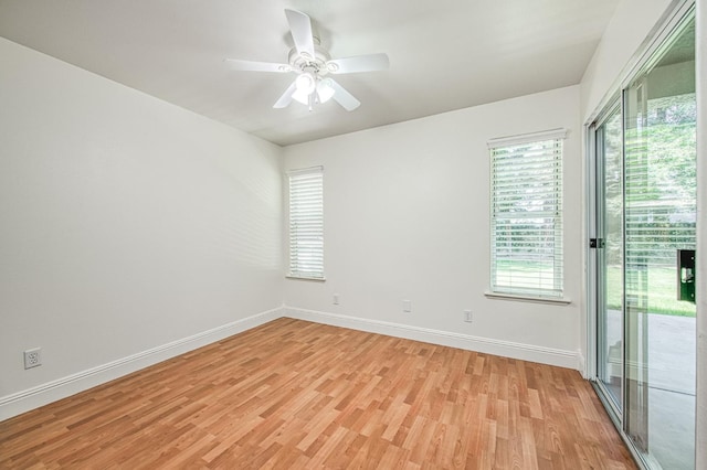 unfurnished room with light wood-style floors, a ceiling fan, baseboards, and plenty of natural light
