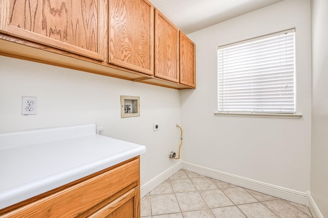 laundry area with baseboards, cabinet space, washer hookup, light tile patterned floors, and hookup for an electric dryer