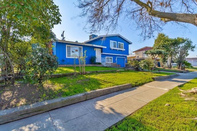 tri-level home with a front yard