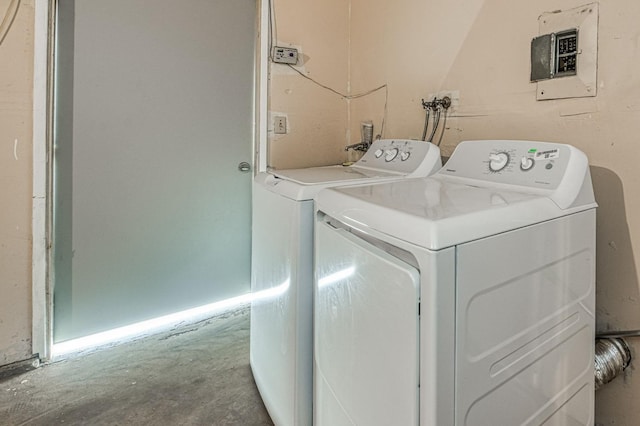 washroom with electric panel, independent washer and dryer, and laundry area