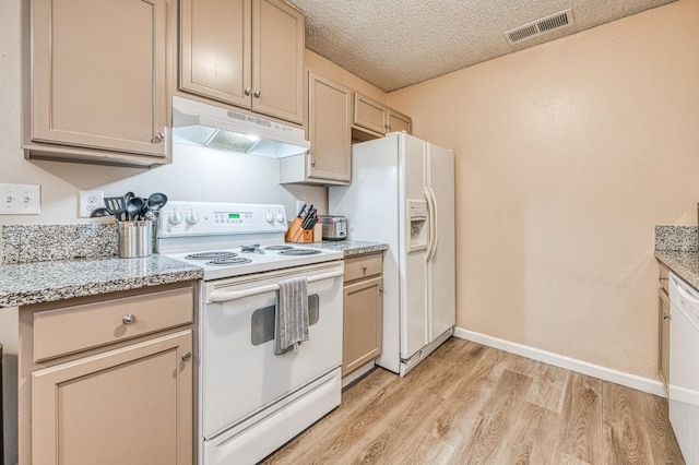 kitchen featuring light wood finished floors, white appliances, a textured ceiling, under cabinet range hood, and visible vents