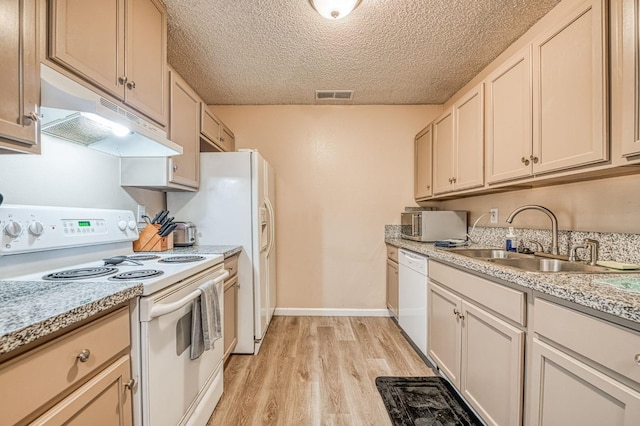 kitchen with visible vents, white appliances, light wood-type flooring, under cabinet range hood, and a sink