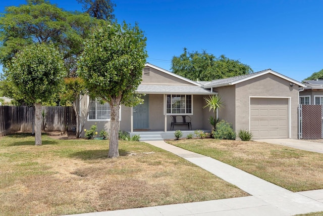 ranch-style house featuring covered porch, driveway, a garage, fence, and stucco siding