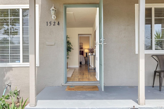 entrance to property with stucco siding