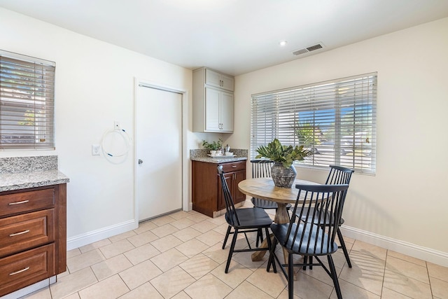 dining space featuring visible vents and baseboards