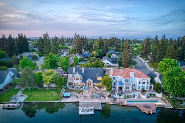 bird's eye view featuring a water view and a residential view
