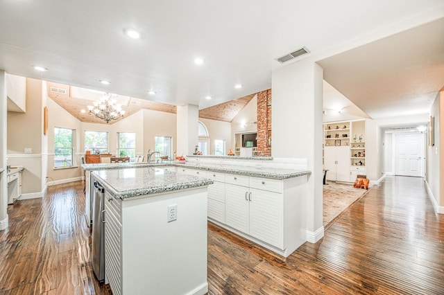 kitchen with an inviting chandelier, baseboards, dark wood finished floors, and lofted ceiling