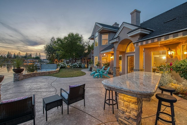view of patio terrace at dusk