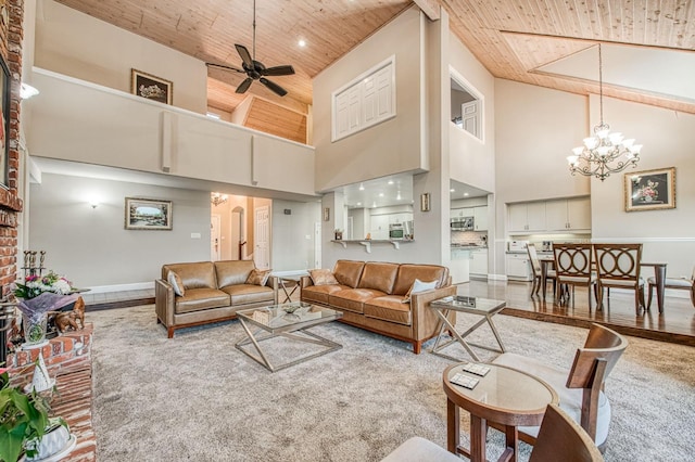 living room featuring carpet, wood ceiling, a towering ceiling, and ceiling fan with notable chandelier