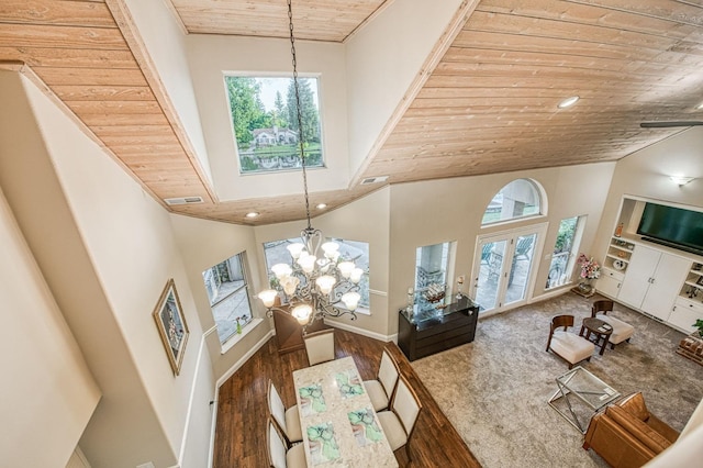 living room with an inviting chandelier, wood finished floors, a healthy amount of sunlight, and high vaulted ceiling