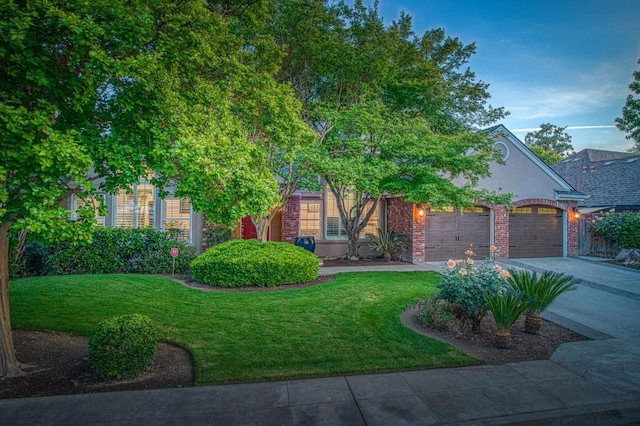 obstructed view of property with concrete driveway, brick siding, an attached garage, and a front yard