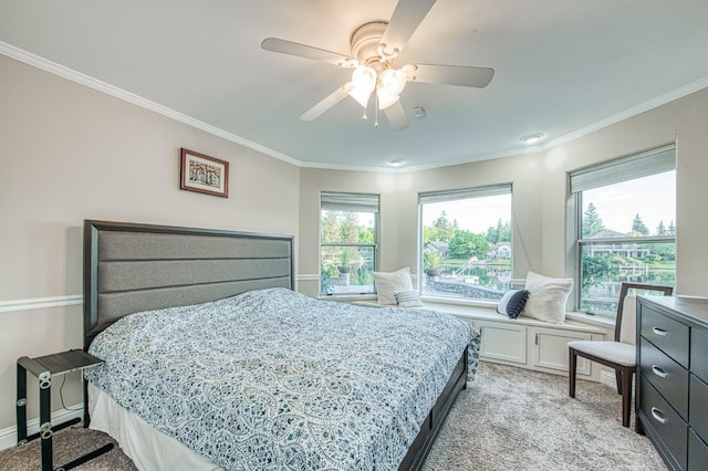 bedroom featuring light colored carpet, crown molding, and ceiling fan
