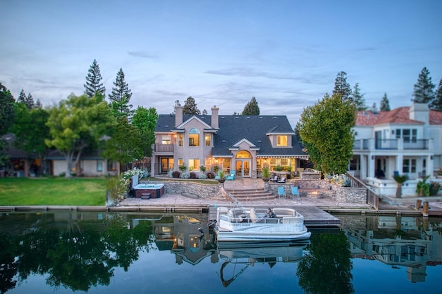 rear view of property with a patio, a chimney, and a balcony