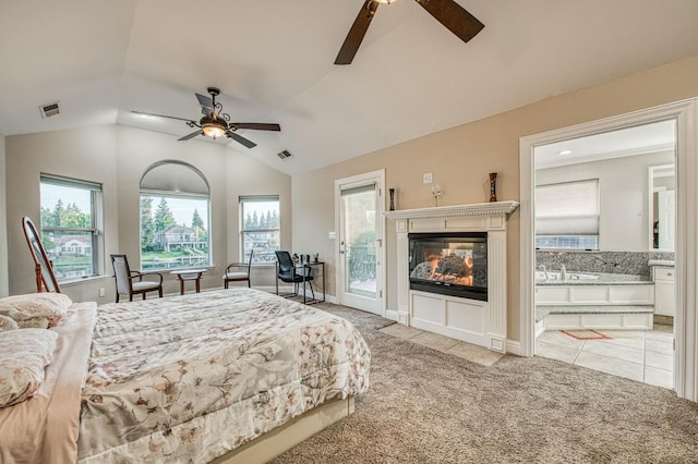 bedroom featuring light carpet, access to exterior, a multi sided fireplace, lofted ceiling, and visible vents