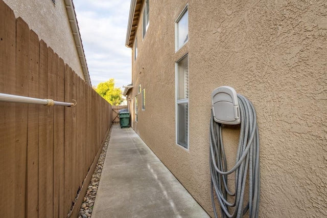 view of property exterior featuring fence and stucco siding