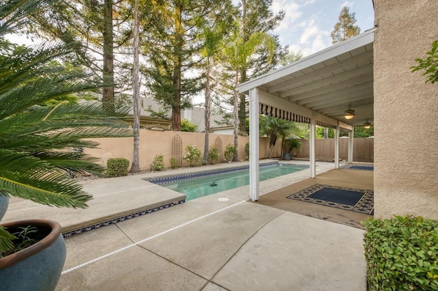 view of pool featuring ceiling fan, a fenced in pool, a fenced backyard, and a patio area