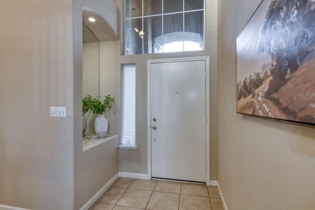 entryway featuring baseboards and tile patterned floors