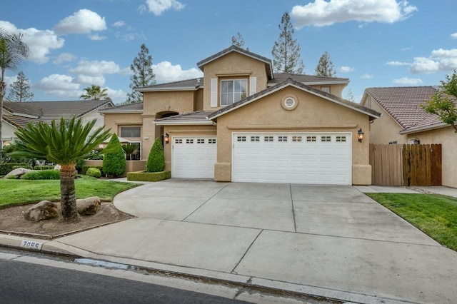 traditional home featuring fence, an attached garage, a front lawn, stucco siding, and concrete driveway