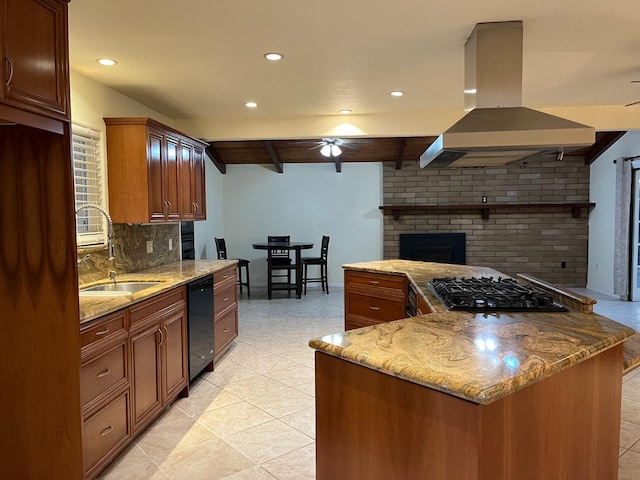 kitchen with ceiling fan, a sink, a fireplace, island range hood, and black appliances