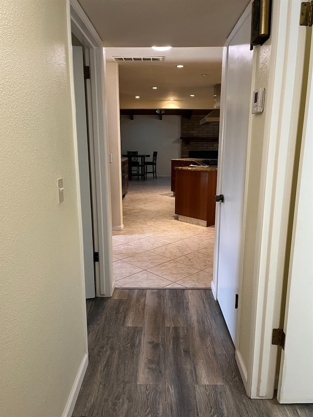 hall with visible vents, recessed lighting, baseboards, and wood finished floors