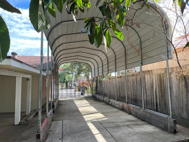 exterior space featuring fence and a carport