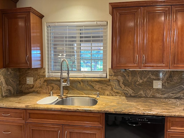 kitchen with black dishwasher, decorative backsplash, and a sink