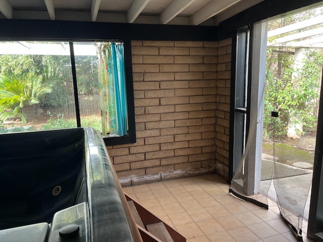 sunroom featuring beamed ceiling