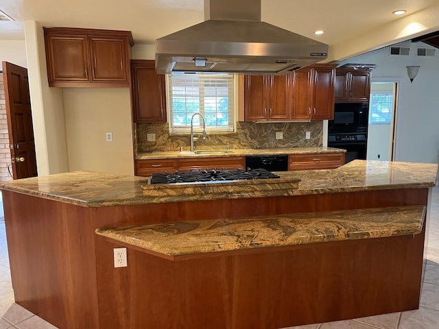 kitchen featuring decorative backsplash, island exhaust hood, a sink, black appliances, and light tile patterned flooring