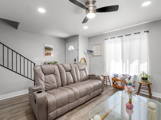 living room featuring baseboards, recessed lighting, stairs, and wood finished floors