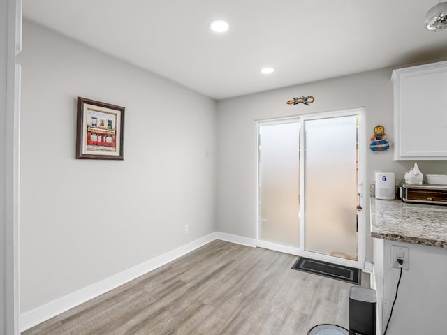 doorway to outside featuring light wood-type flooring, recessed lighting, and baseboards