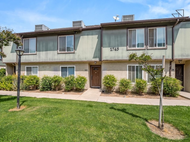 multi unit property featuring central AC and a front yard