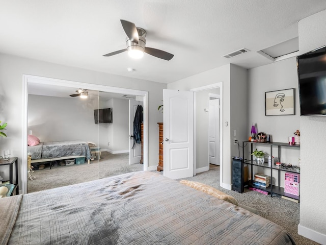 carpeted bedroom with a ceiling fan, baseboards, visible vents, and a closet