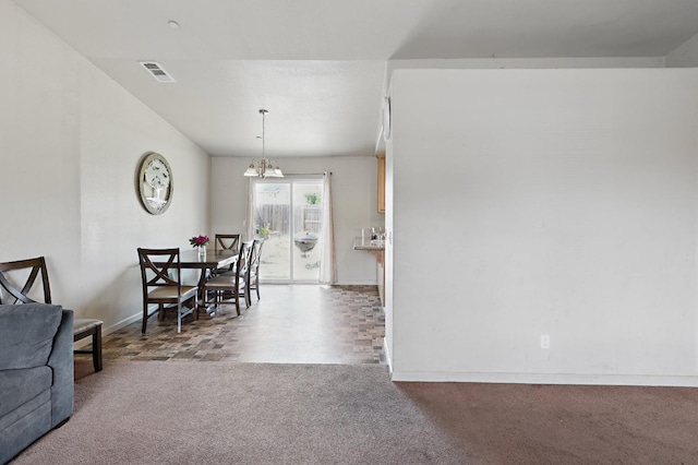 dining area featuring carpet floors, a chandelier, baseboards, and visible vents