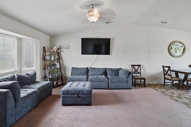 carpeted living area featuring a ceiling fan, vaulted ceiling, and visible vents