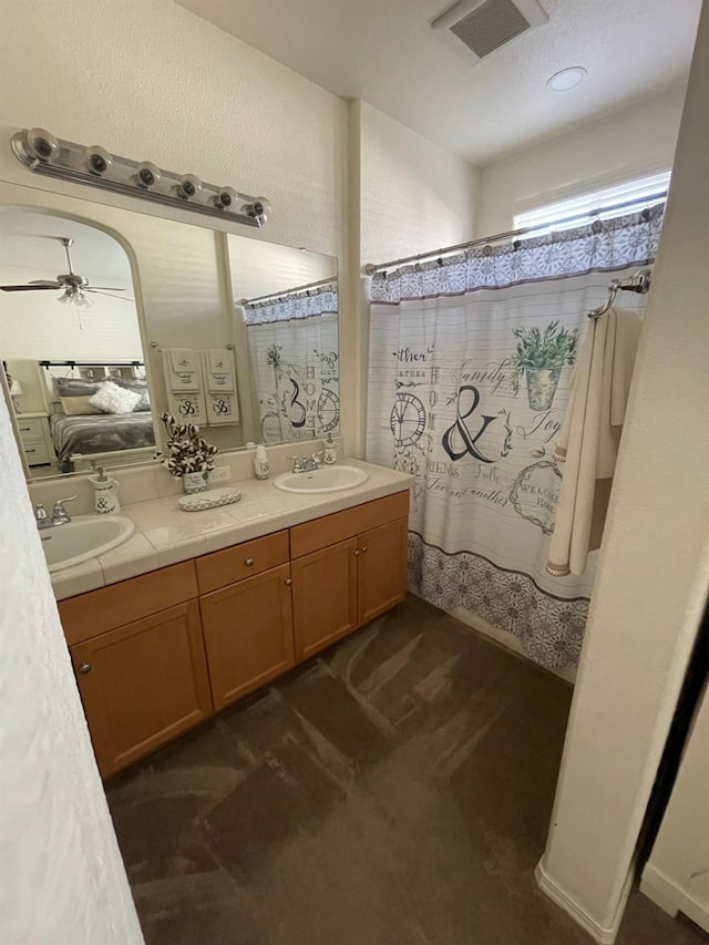 full bath with double vanity, visible vents, and a sink