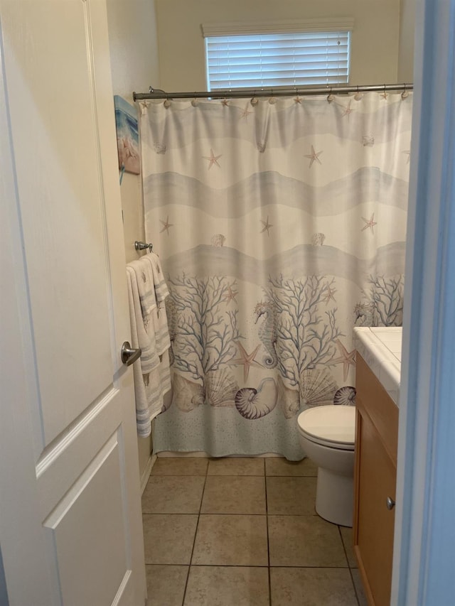 bathroom featuring vanity, tile patterned floors, a wealth of natural light, and toilet