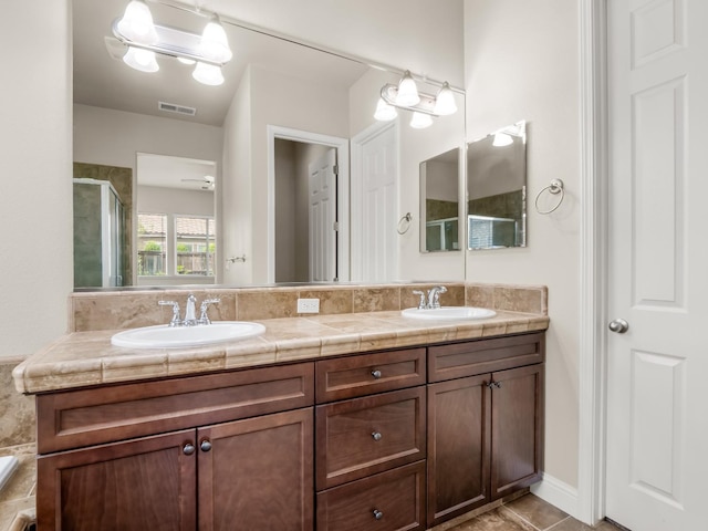 7993 N Justin Ave, Fresno, CA 93720 - full bath featuring visible vents, a sink, double vanity, and a shower stall
