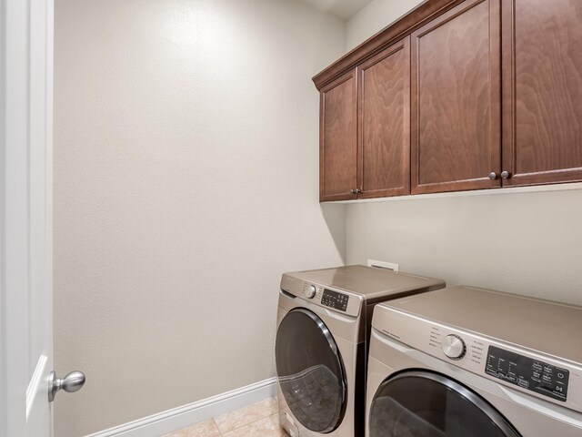 7993 N Justin Ave, Fresno, CA 93720 - washroom with baseboards, tile patterned floors, cabinet space, and washing machine and dryer
