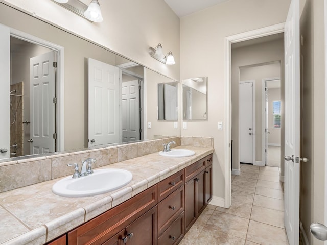 7993 N Justin Ave, Fresno, CA 93720 - full bath featuring double vanity, baseboards, a sink, and tile patterned flooring