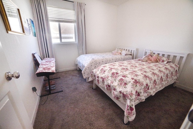 carpeted bedroom featuring baseboards