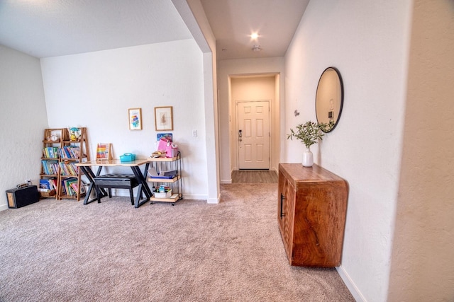 corridor featuring carpet floors and baseboards