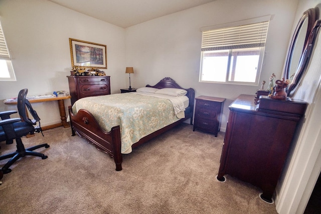 bedroom with baseboards and light carpet