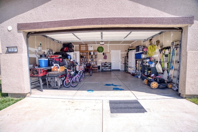 garage featuring concrete driveway and a garage door opener