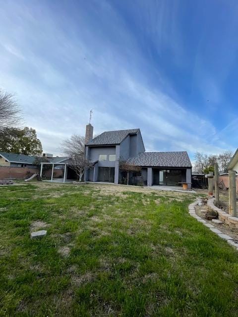 2791 W Kofoid Ave, Caruthers, CA 93609 - rear view of house featuring fence, a yard, and a chimney