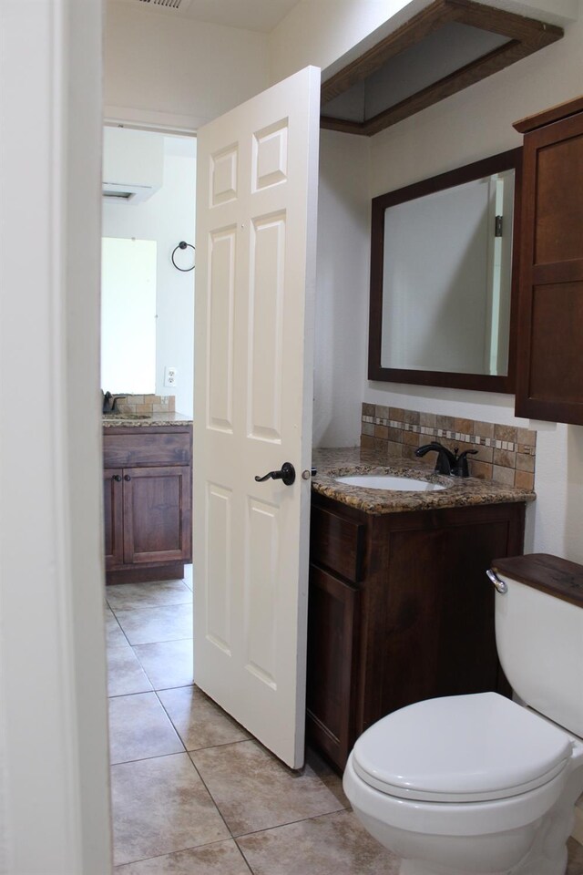 2791 W Kofoid Ave, Caruthers, CA 93609 - half bathroom featuring vanity, tile patterned floors, and toilet