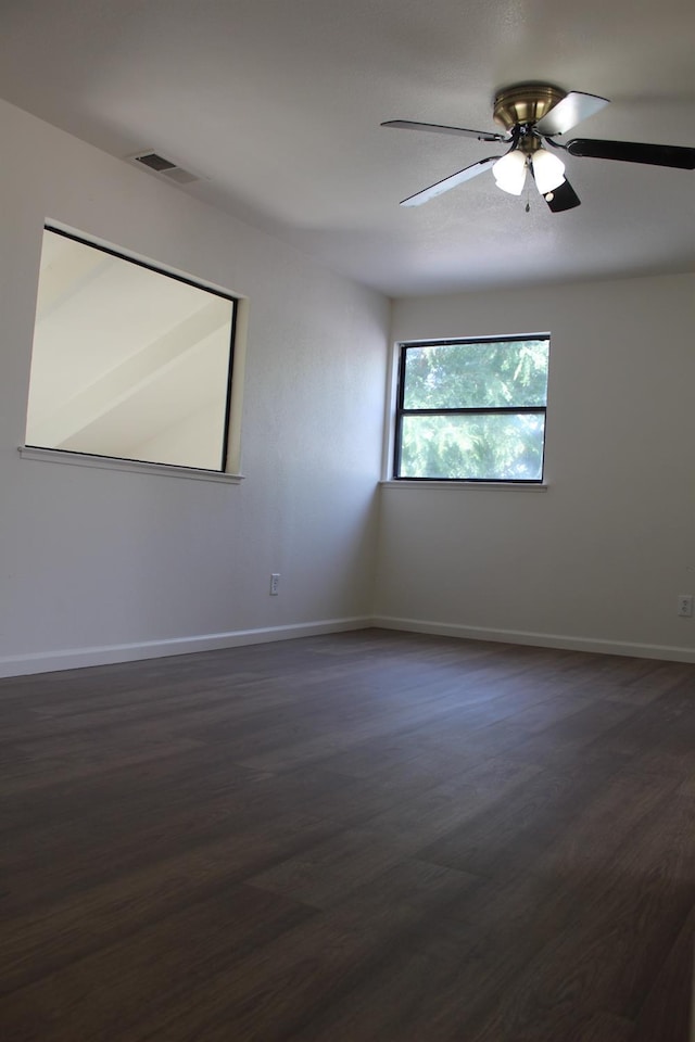 2791 W Kofoid Ave, Caruthers, CA 93609 - unfurnished room with baseboards, ceiling fan, dark wood-style flooring, and visible vents
