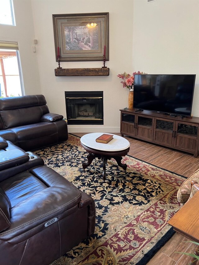 9552 N Whitehouse Dr, Fresno, CA 93720 - living room with a glass covered fireplace, wood finished floors, and baseboards