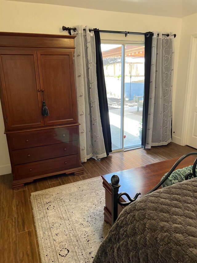 9552 N Whitehouse Dr, Fresno, CA 93720 - bedroom with access to exterior, dark wood finished floors, and baseboards